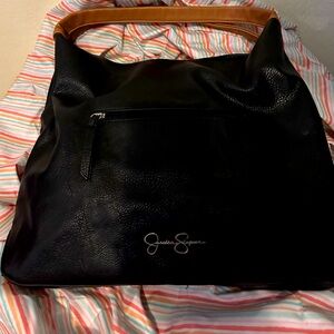 Jessica Simpson tote is lrg and black with tan accents 8 separate compartments.